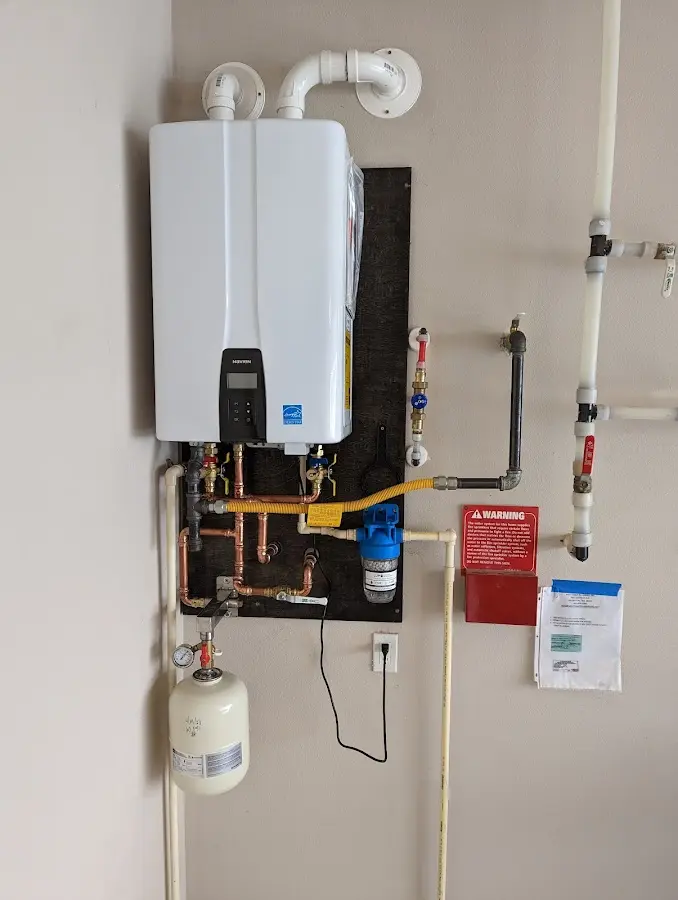 Professional plumber installing copper piping in a Muldrow home